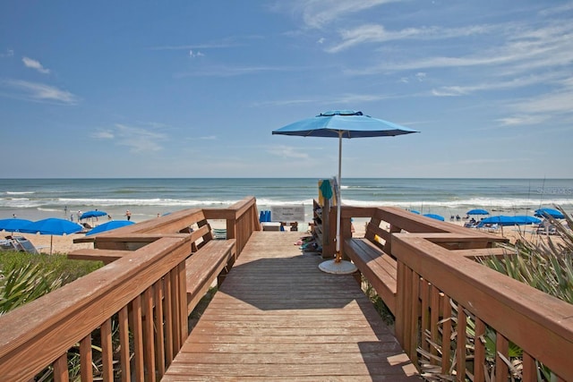 view of community with a water view and a view of the beach