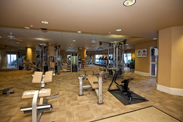 workout area with ceiling fan and light carpet