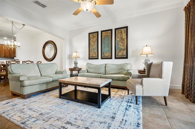 tiled living room featuring crown molding and ceiling fan with notable chandelier