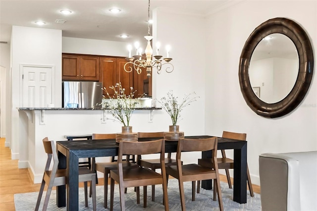 200 Cinnamon Beach Way Unit 122, Palm Coast, FL 32137 - dining room with a chandelier, baseboards, light wood-style flooring, recessed lighting, and ornamental molding