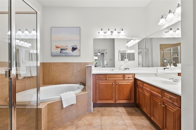 200 Cinnamon Beach Way Unit 122, Palm Coast, FL 32137 - full bathroom with a stall shower, tile patterned flooring, a garden tub, and double vanity