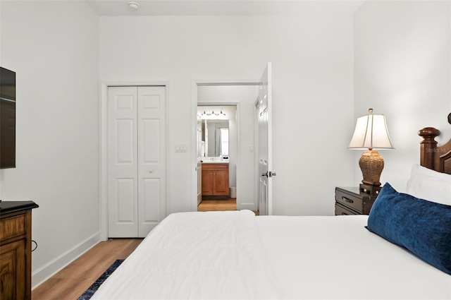 200 Cinnamon Beach Way Unit 122, Palm Coast, FL 32137 - bedroom with light wood-style floors, baseboards, a closet, and ensuite bath