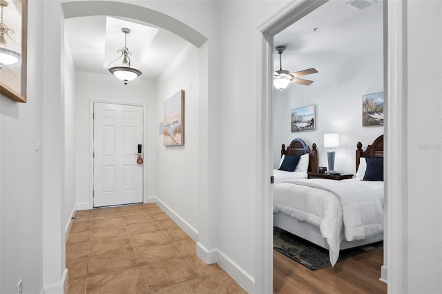 200 Cinnamon Beach Way Unit 122, Palm Coast, FL 32137 - hallway with arched walkways, baseboards, and light tile patterned floors
