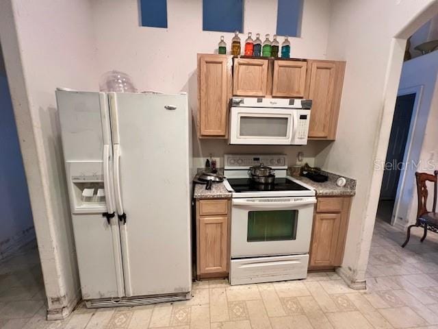 kitchen with light tile patterned flooring and white appliances