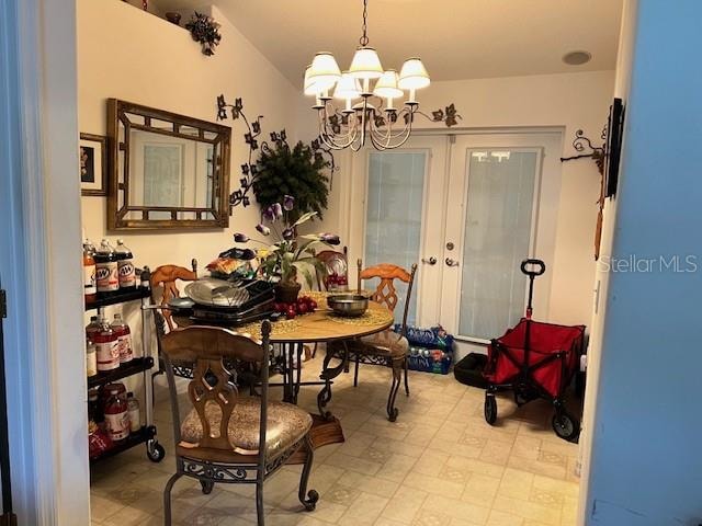 dining room with light tile patterned flooring, french doors, and an inviting chandelier