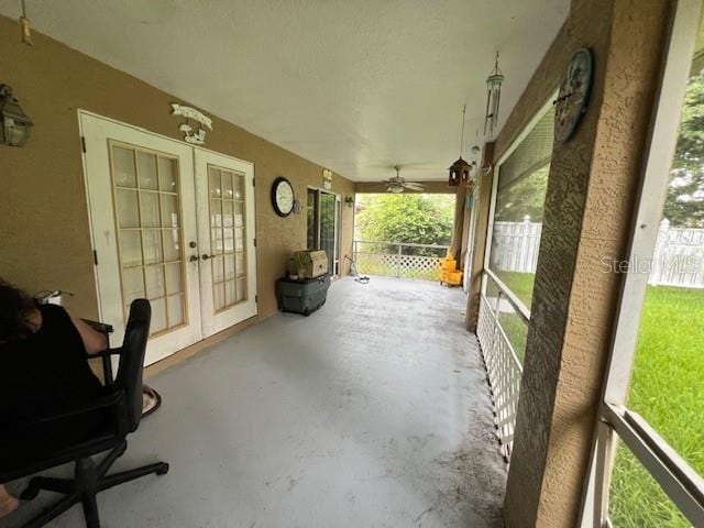 sunroom / solarium featuring ceiling fan and french doors