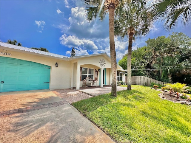 single story home with a front yard, a garage, and a porch