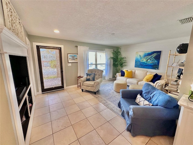 living room with light tile patterned floors and a textured ceiling