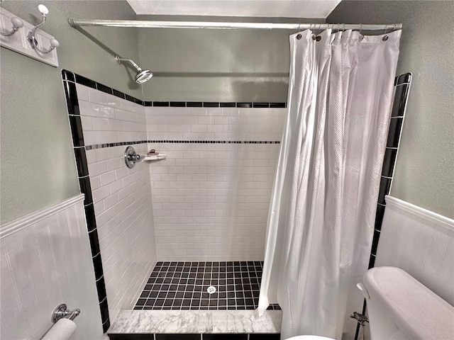 bathroom with a shower with curtain and toilet