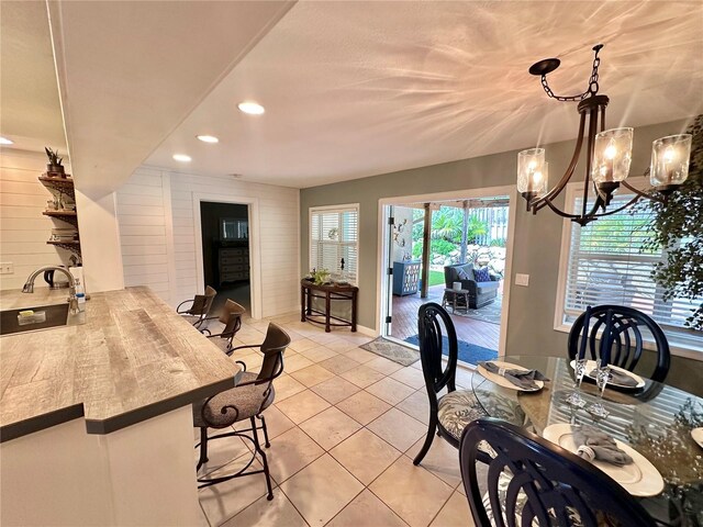 dining room with light tile patterned floors and a chandelier