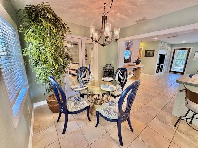 dining area with a notable chandelier and light tile patterned flooring