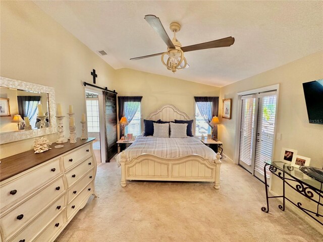 carpeted bedroom with ceiling fan, a barn door, access to outside, and vaulted ceiling