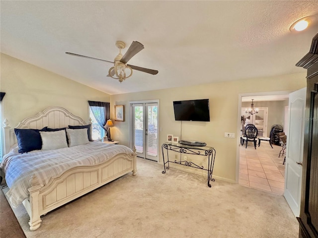 bedroom featuring vaulted ceiling, ceiling fan with notable chandelier, and light colored carpet