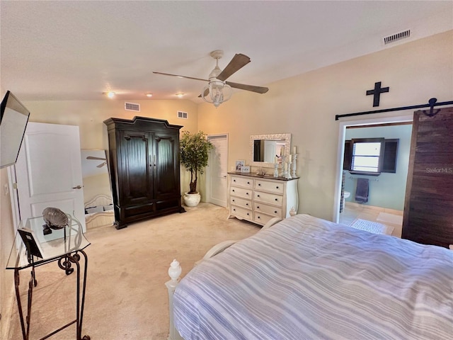 carpeted bedroom featuring ceiling fan, a barn door, and lofted ceiling