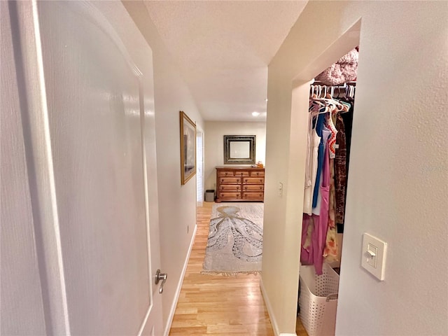 hallway with light hardwood / wood-style flooring