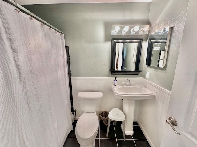 bathroom with tile patterned floors and toilet