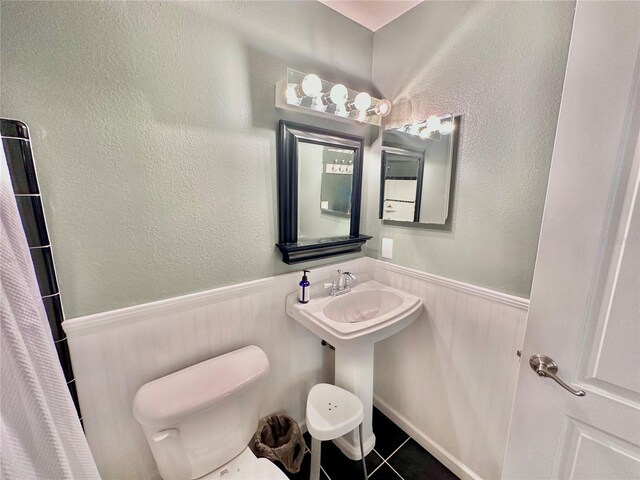 bathroom featuring tile patterned floors, sink, and toilet