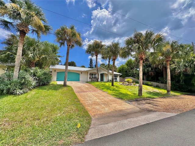 view of front of house with a front yard and a garage