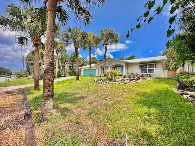 view of front of house featuring a front yard and a garage