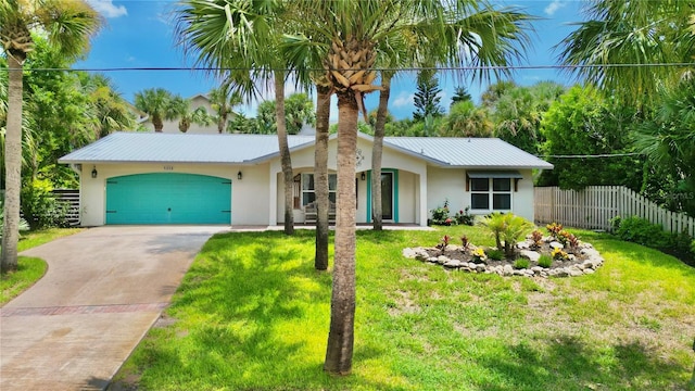 single story home featuring a front yard and a garage