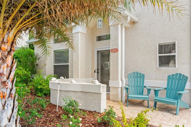 doorway to property with a patio area