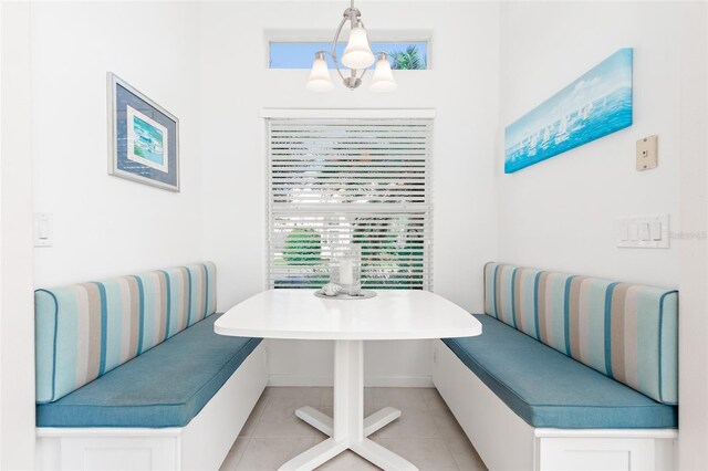 dining space featuring a notable chandelier, breakfast area, and light tile patterned flooring