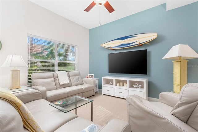 carpeted living room with ceiling fan