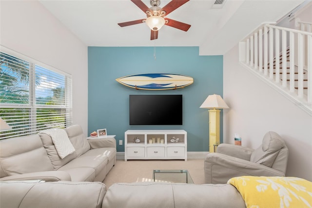 carpeted living room featuring ceiling fan