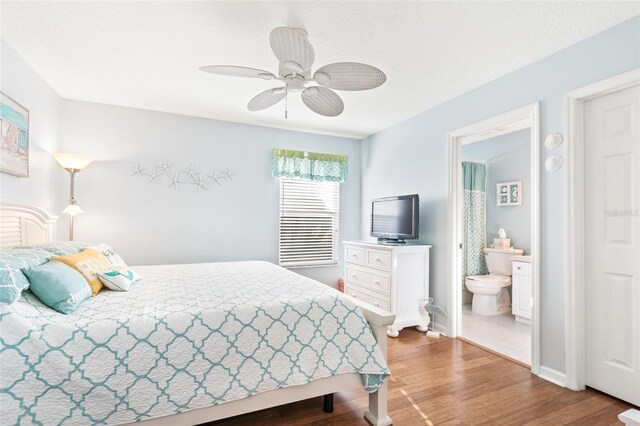 bedroom with ceiling fan, hardwood / wood-style flooring, and connected bathroom