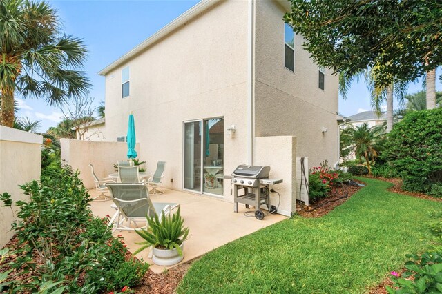 rear view of property with a patio area and a lawn