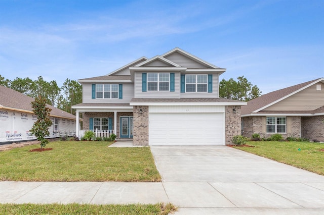 craftsman inspired home featuring a garage, covered porch, and a front lawn