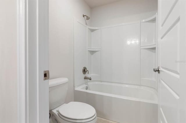 bathroom featuring bathtub / shower combination and toilet