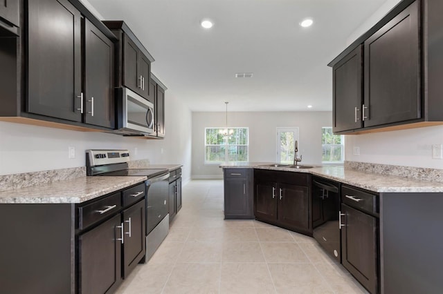 kitchen featuring light tile patterned flooring, sink, decorative light fixtures, kitchen peninsula, and stainless steel appliances