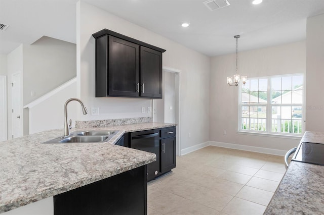 kitchen with light tile patterned flooring, dishwasher, sink, hanging light fixtures, and stove