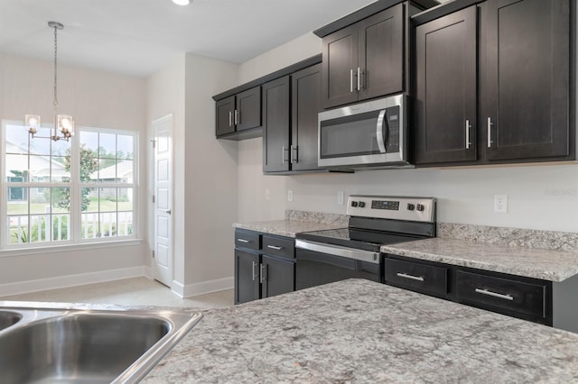 kitchen with hanging light fixtures, dark brown cabinets, stainless steel appliances, and a chandelier