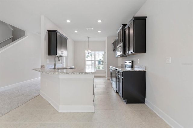 kitchen with appliances with stainless steel finishes, sink, light colored carpet, light stone countertops, and an inviting chandelier