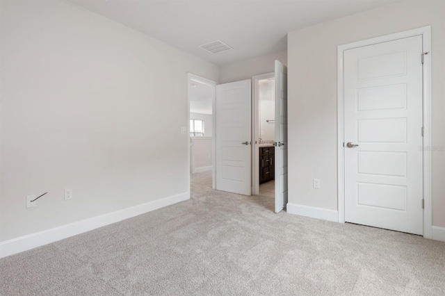 unfurnished bedroom with light colored carpet