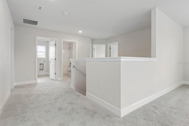 corridor with light colored carpet