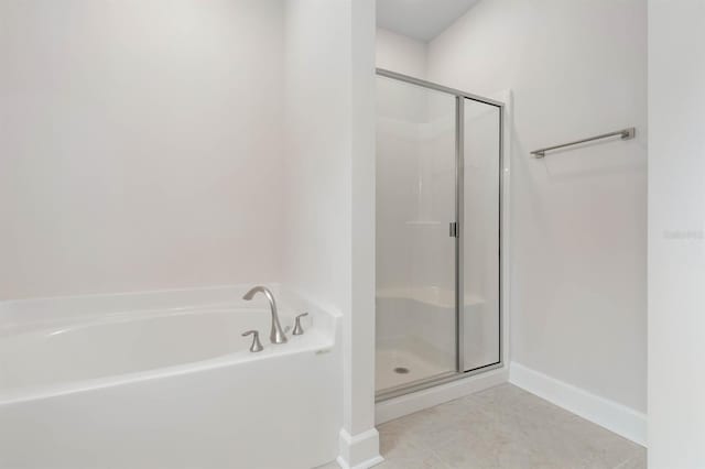 bathroom featuring tile patterned floors and independent shower and bath