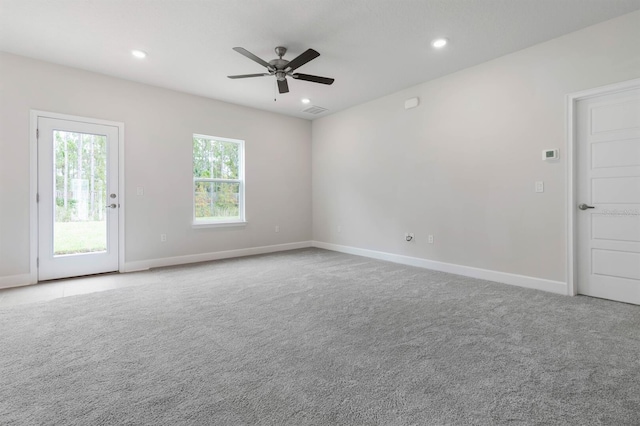 carpeted spare room with ceiling fan