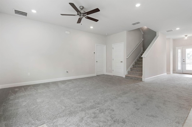 unfurnished living room featuring ceiling fan and light colored carpet