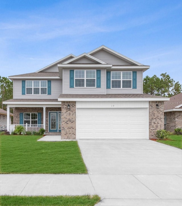 view of front of home featuring a garage, a front lawn, and a porch