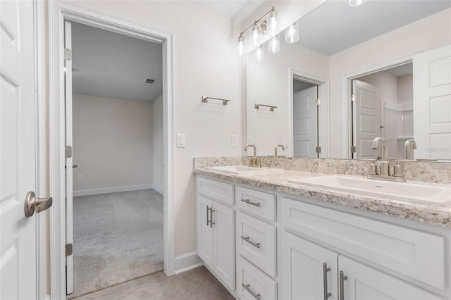 full bathroom featuring a sink, visible vents, baseboards, and double vanity