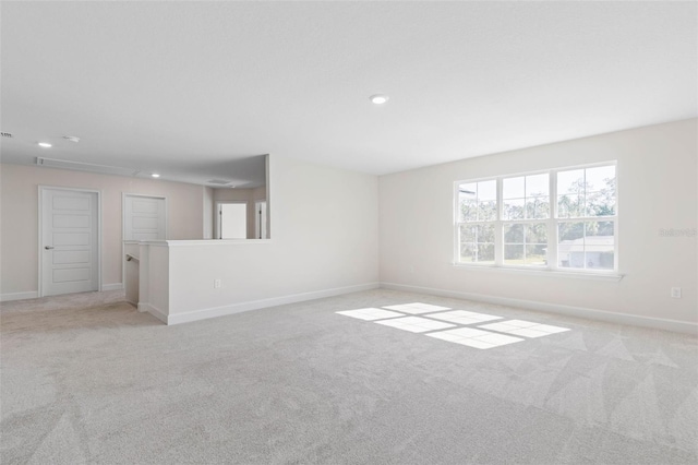 unfurnished living room featuring recessed lighting, baseboards, and carpet floors