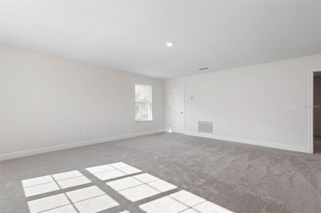 carpeted empty room featuring recessed lighting, baseboards, and visible vents