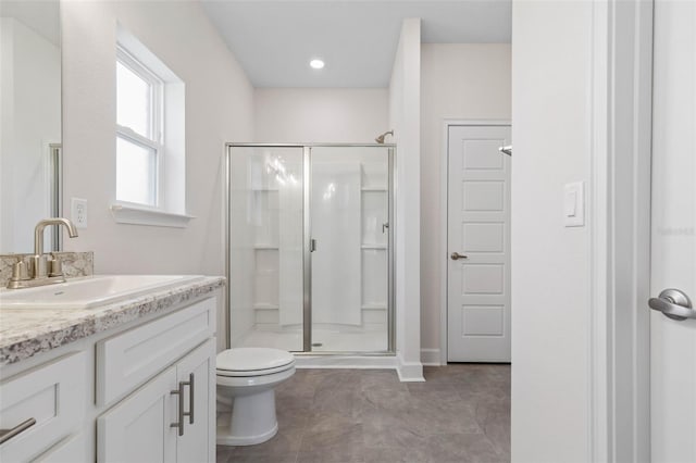 bathroom with tile patterned flooring, a shower stall, vanity, and toilet