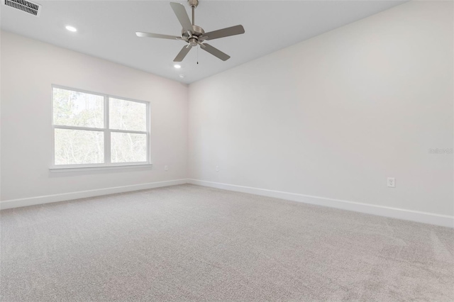 empty room with recessed lighting, baseboards, visible vents, and light carpet