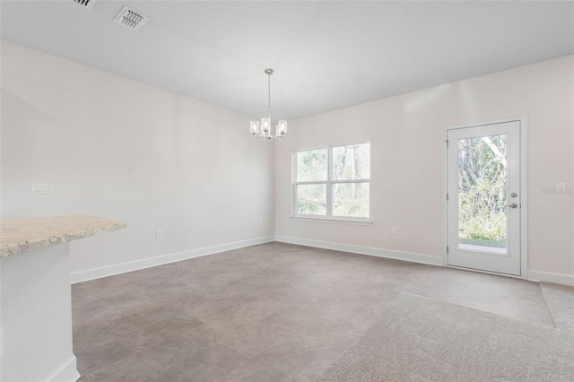 spare room with visible vents, baseboards, and an inviting chandelier