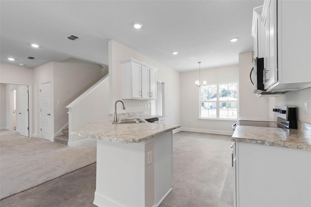 kitchen featuring electric range oven, a sink, light carpet, white cabinetry, and stainless steel microwave