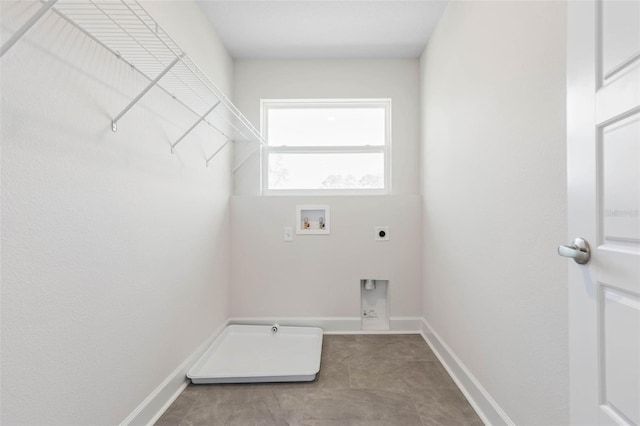 clothes washing area with laundry area, hookup for an electric dryer, baseboards, and washer hookup